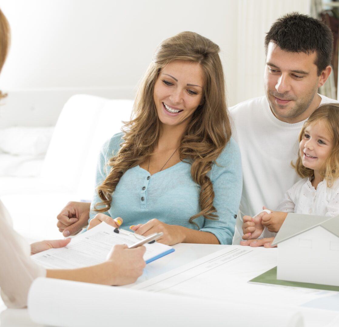 Group 1321316683 (11) (4) A family sitting at the table with papers and pens