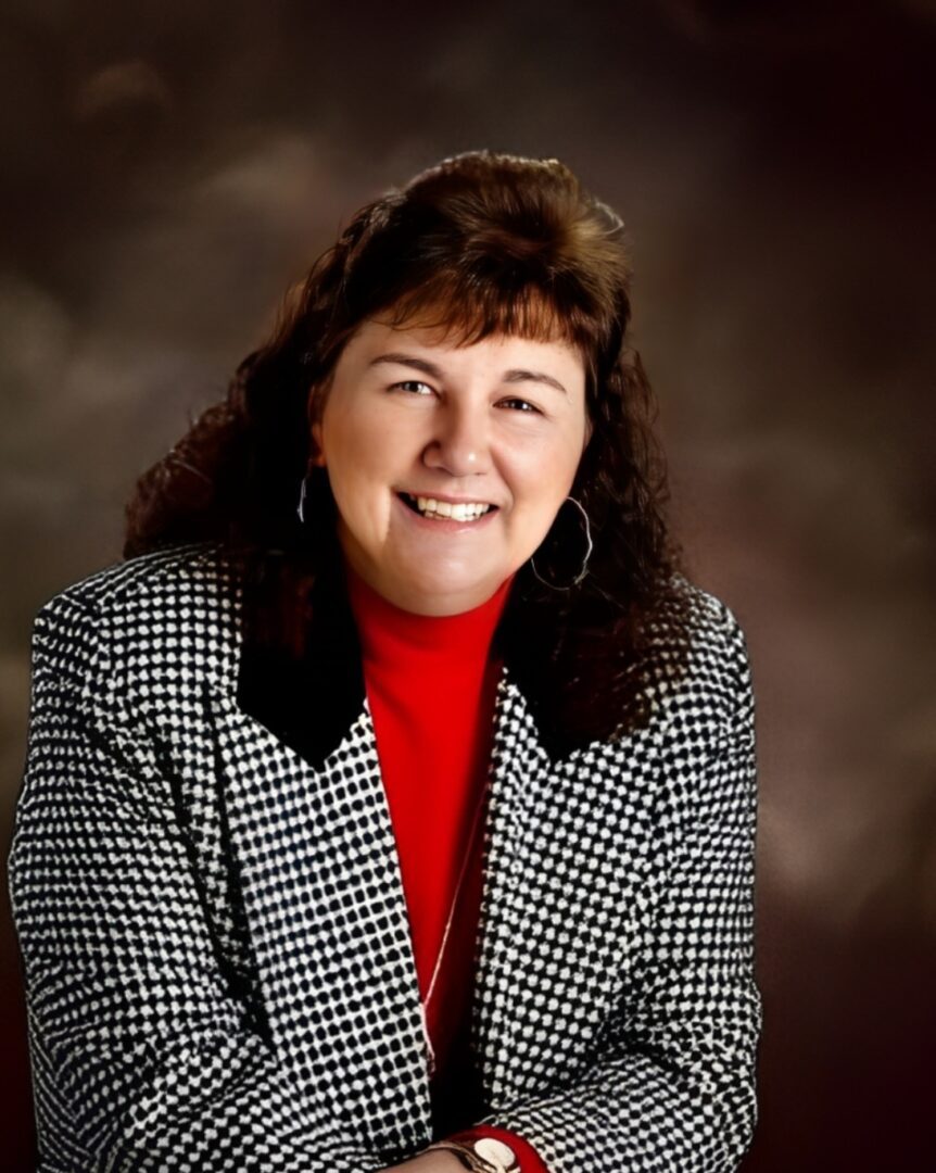 person-3 (1) A woman in a red shirt and black jacket